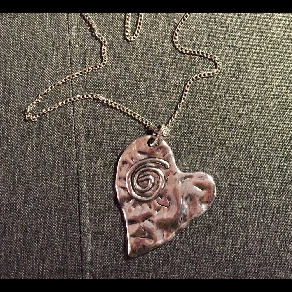 Large heart shaped necklace with long chain.